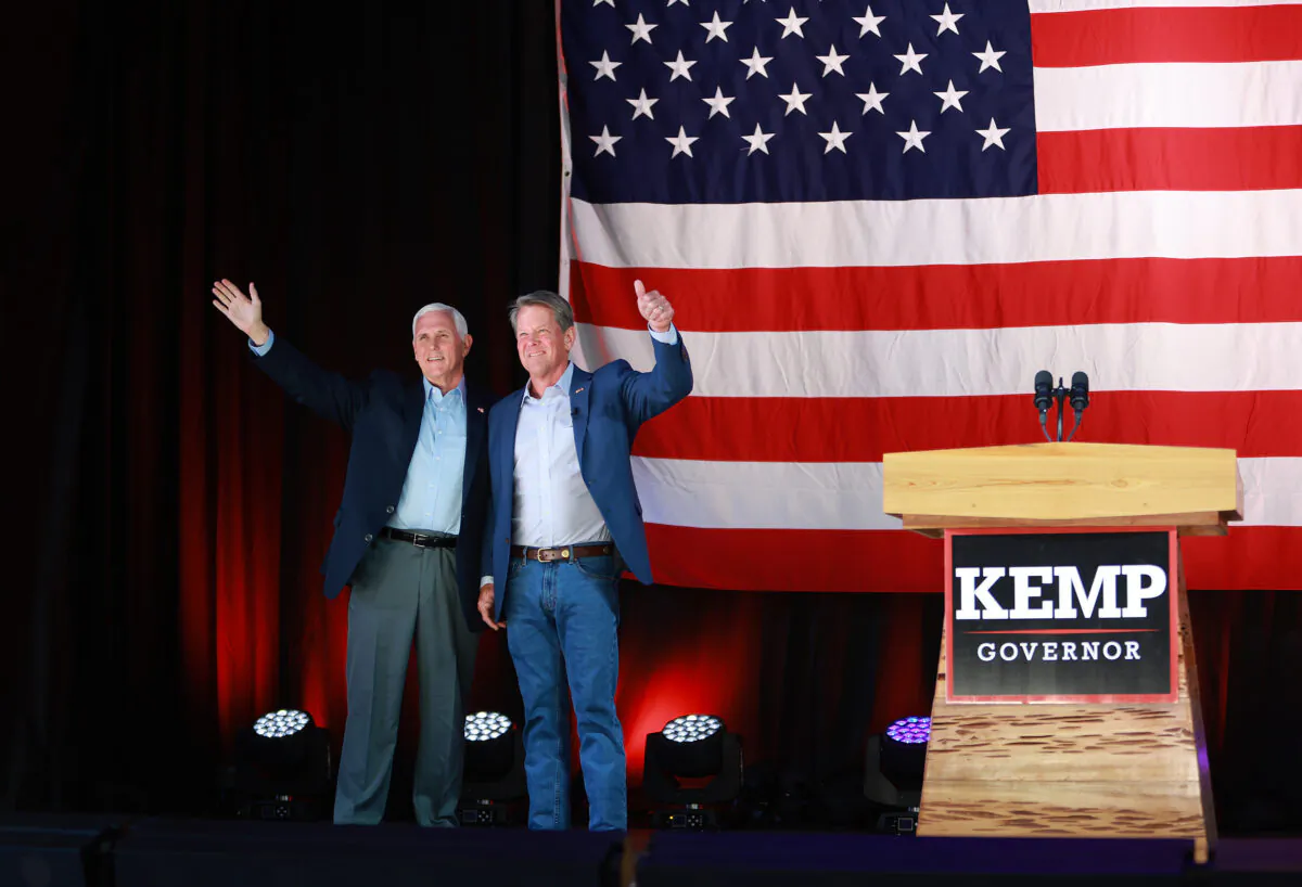 Georgia Gov. Brian Kemp (R) stands with former U.S. Vice President Mike Pence at a campaign event at the Cobb County International Airport on May 23, 2022 in Kennesaw, Georgia. Kemp is running for reelection against former U.S Sen. David Perdue in tomorrow's Republican gubernatorial primary. (Joe Raedle/Getty Images)