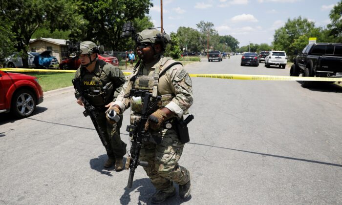 Law enforcement personnel guard the scene of a shooting at Robb Elementary School in Uvalde, Texas, on May 24, 2022. (Marco Bello/Reuters)