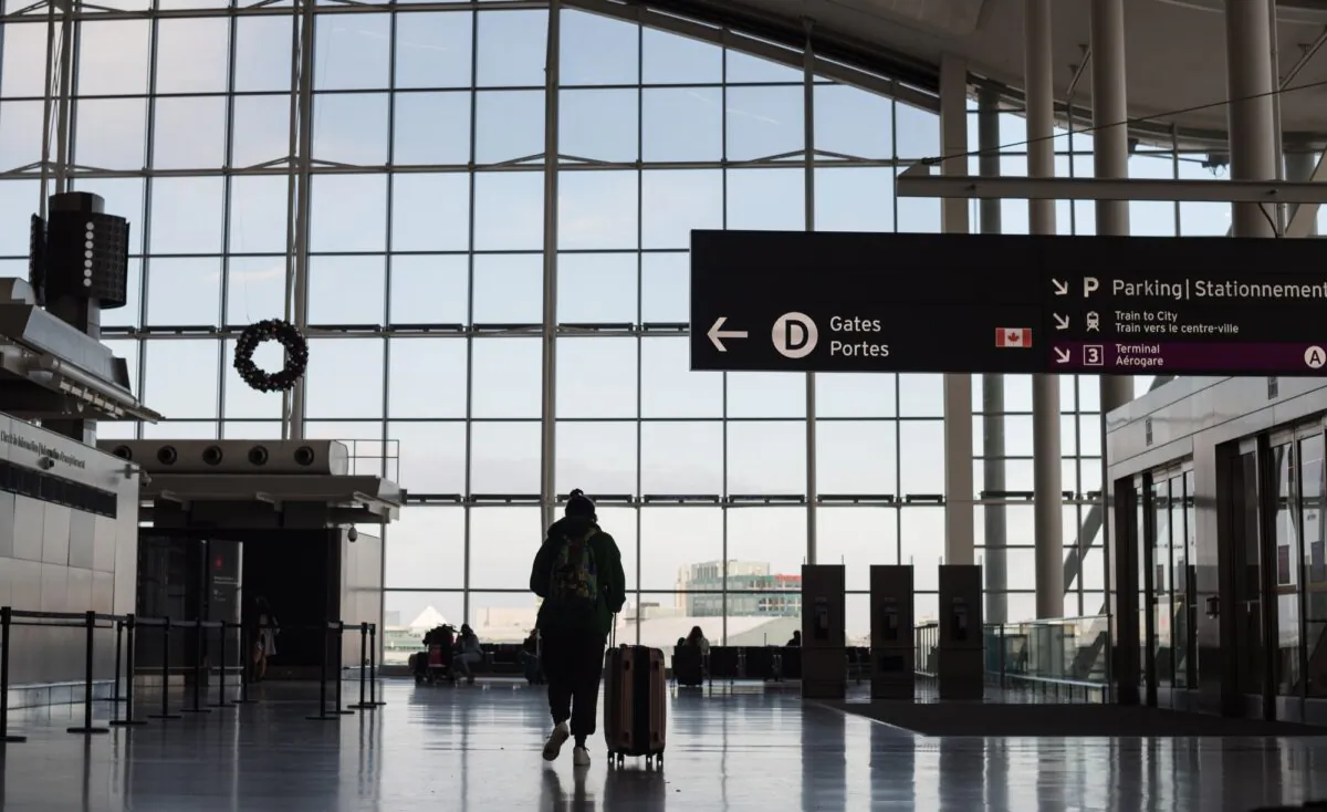 Travellers are photographed at Toronto Pearson International Airport on Dec. 16, 2021. (Tijana Martin/The Canadian Press)