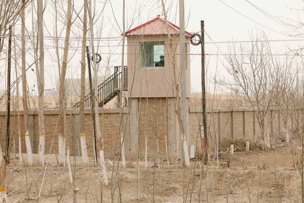 FILE - A security person watches from a guard tower around a detention facility in Yarkent County in northwestern China's Xinjiang Uyghur Autonomous Region on March 21, 2021. Allegations of human rights abuses in China's northwestern Xinjiang region are the dominant issue on a visit by the United Nations' top rights official that starts Monday, May 23, 2022. changes are needed to fight Islamic extremism. (AP Photo/Ng Han Guan, File)