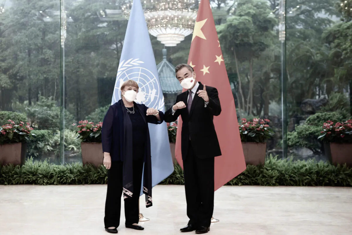 Chinese Foreign Minister Wang Yi (R) meets with the United Nations High Commissioner for Human Rights Michelle Bachelet in Guangzhou, southern China's Guangdong Province, on May 23, 2022. (Deng Hua/Xinhua via AP)