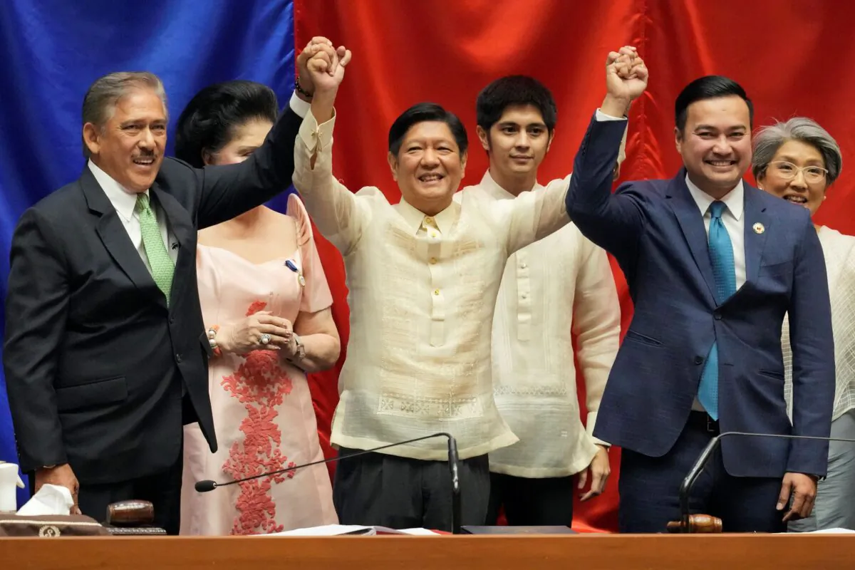 President-elect Ferdinand "Bongbong" Marcos Jr. (C) raises hands with Senate President Vicente Sotto III, left, and House Speaker Lord Allan Velasco during his proclamation at the House of Representatives, Quezon City, Philippines, on May 25, 2022. (Aaron Favila/AP Photo)