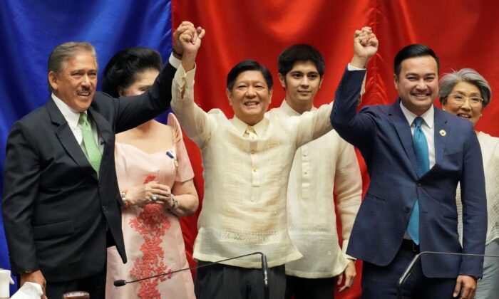 President-elect Ferdinand "Bongbong" Marcos Jr. (C) raises hands with Senate President Vicente Sotto III, left, and House Speaker Lord Allan Velasco during his proclamation at the House of Representatives, Quezon City, Philippines, on May 25, 2022. (Aaron Favila/AP Photo)