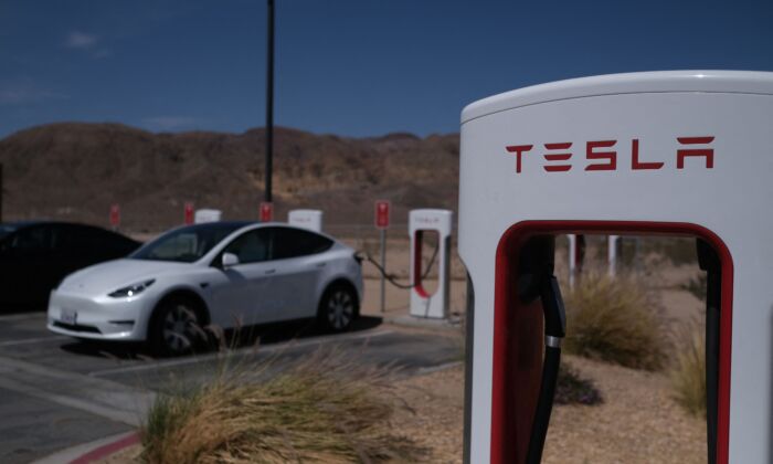 Tesla cars sit at charging stations in Yermo, Calif., on May 14, 2022. (Chris Delmas/AFP via Getty Images)