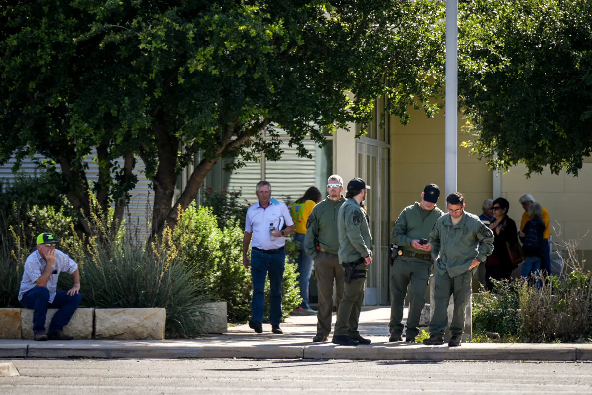 Law enforcement officials at the Uvalde Civic Center, which is operating as a grief counseling location for community members affected by the mass shooting at Robb Elementary School the day prior, in Uvalde, Texas, on May 24, 2022. (Charlotte Cuthbertson/The Epoch Times)