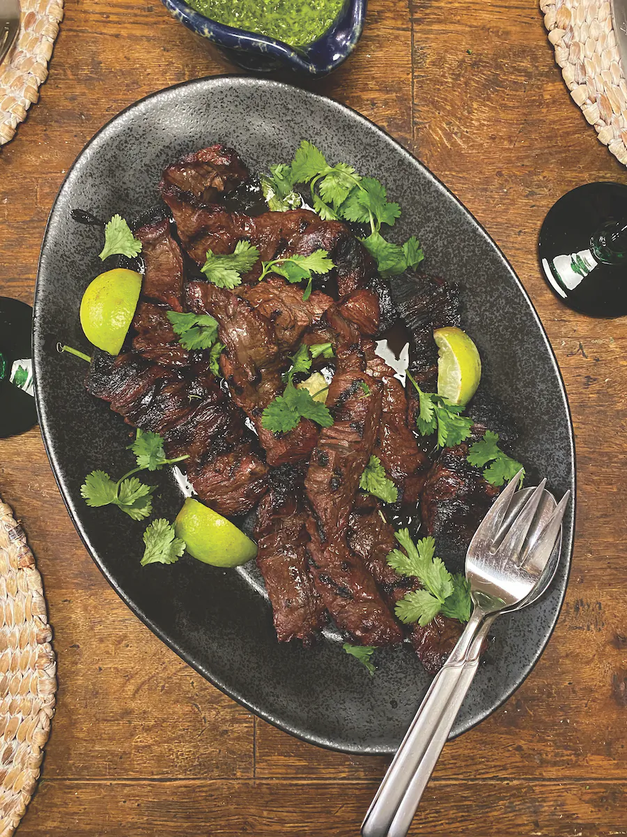 A simple marinade of soy sauce, brown sugar, lime juice, and Sriracha tenderizes and flavors this steak before it hits the grill. (Lynda Balslev for Tastefood)