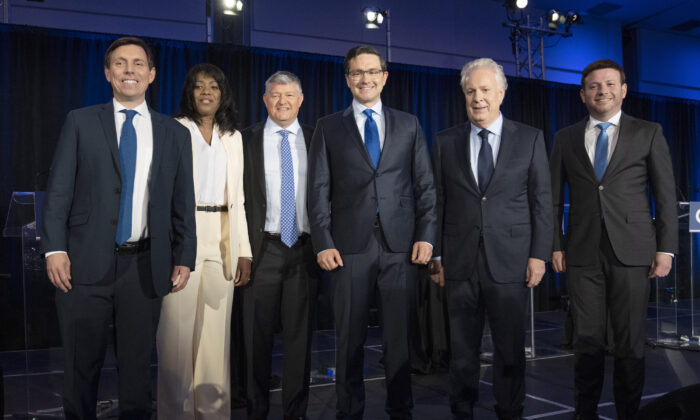 (L-R) Conservative Party leadership candidates Patrick Brown, Leslyn Lewis, Scott Aitchison, Pierre Poilievre, Jean Charest, and Roman Baber pose for photos after the French-language debate in Laval, Que., on May 25, 2022. (The Canadian Press/Ryan Remiorz)