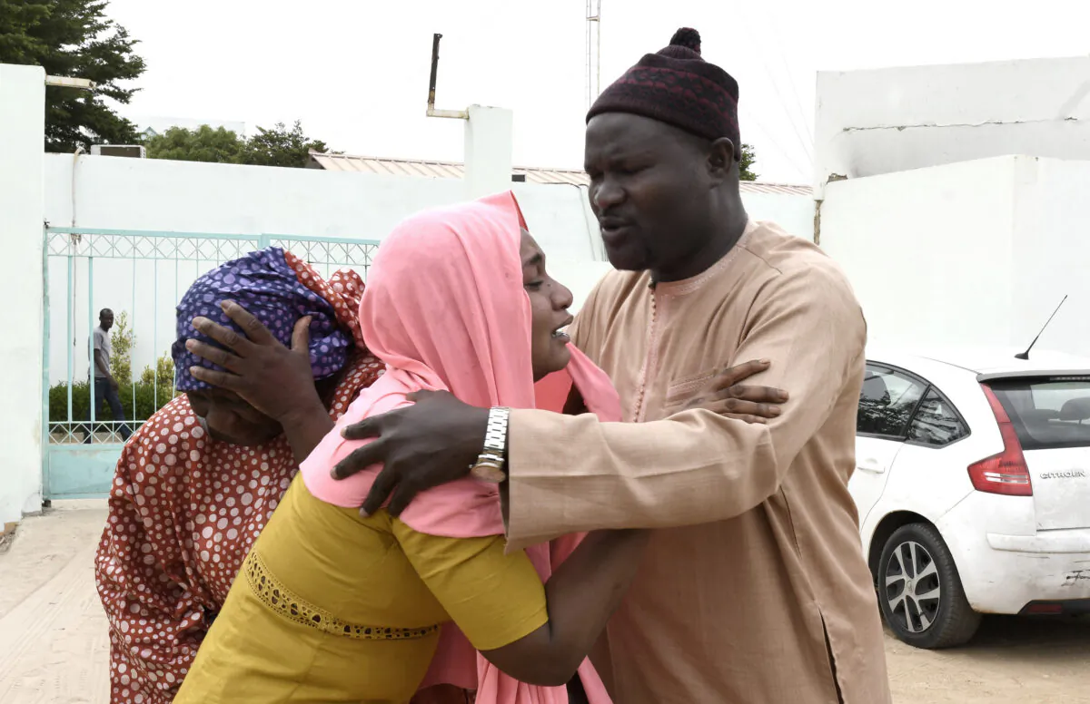 Family members console each other outside the Mame Abdoul Aziz Sy Dabakh Hospital, where eleven babies died following an electrical fault, in Tivaouane, Senegal, on May 26, 2022. (Seyllou/AFP via Getty Images)