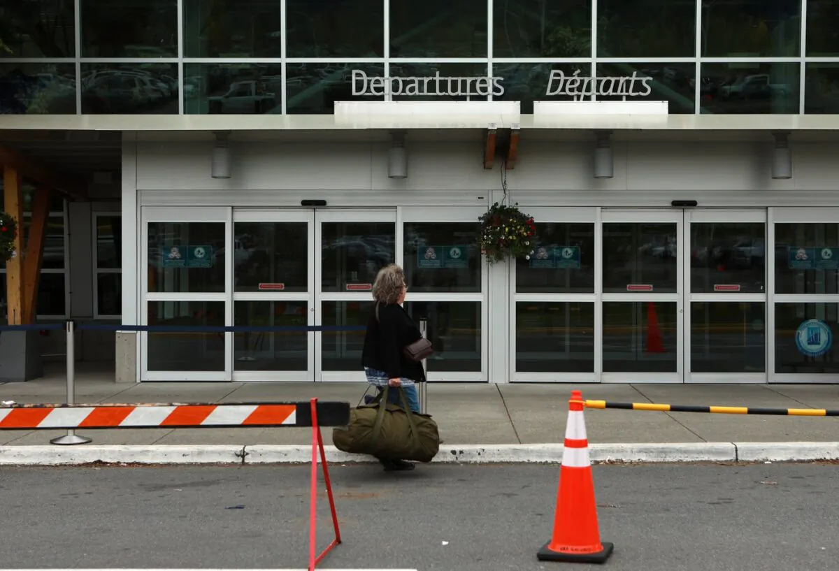 A person stands outside Victoria International Airport in Sidney, B.C., on May 24, 2022. (The Canadian Press/Chad Hipolito)