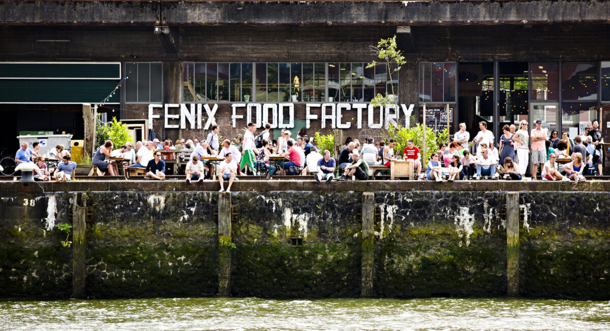 People enjoying the sun at the Fenix Food Factory in Katendrecht, Rotterdam. (Iris van den Broek/ Shutterstock)