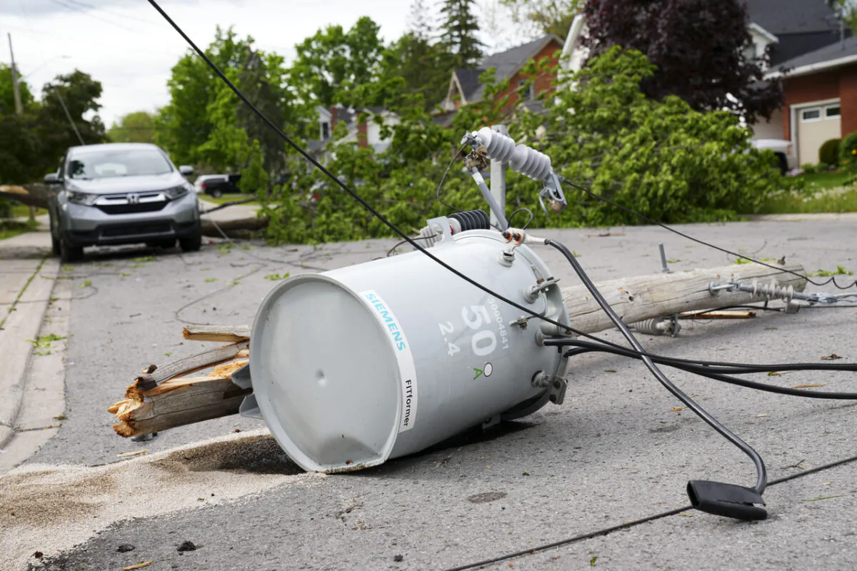 Hydro infrastructure and trees sit broken on a street in the Ottawa Valley municipality of Carleton Place, Ont. on May 23, 2022. A major storm hit the parts of Ontario and Quebec on May 21, 2022, leaving extensive damage to infrastructure. (The Canadian Press/Sean Kilpatrick)