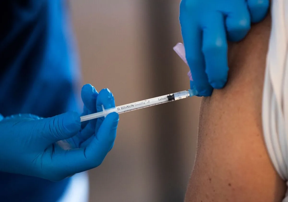 A health worker vaccinates an elderly person with the BioNTech-Pfizer COVID-19 vaccine at a temporary vaccination clinic in a church in Sollentuna, north of Stockholm, on March 2, 2021. (Fredrik Sandberg/TT News Agency/AFP via Getty Images)