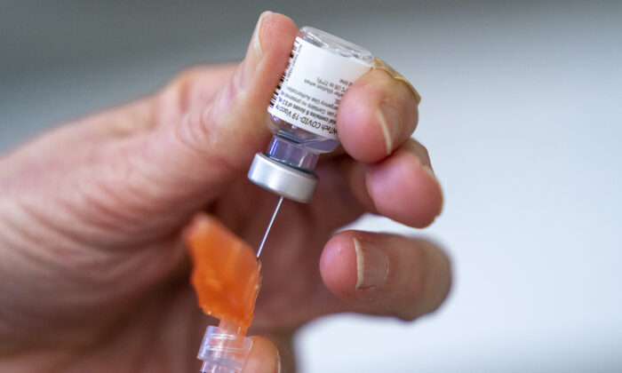 A syringe is loaded with COVID-19 vaccine at a vaccination clinic run by Vancouver Coastal Health, in Richmond, B.C., on April 10, 2021. (The Canadian Press/Jonathan Hayward)