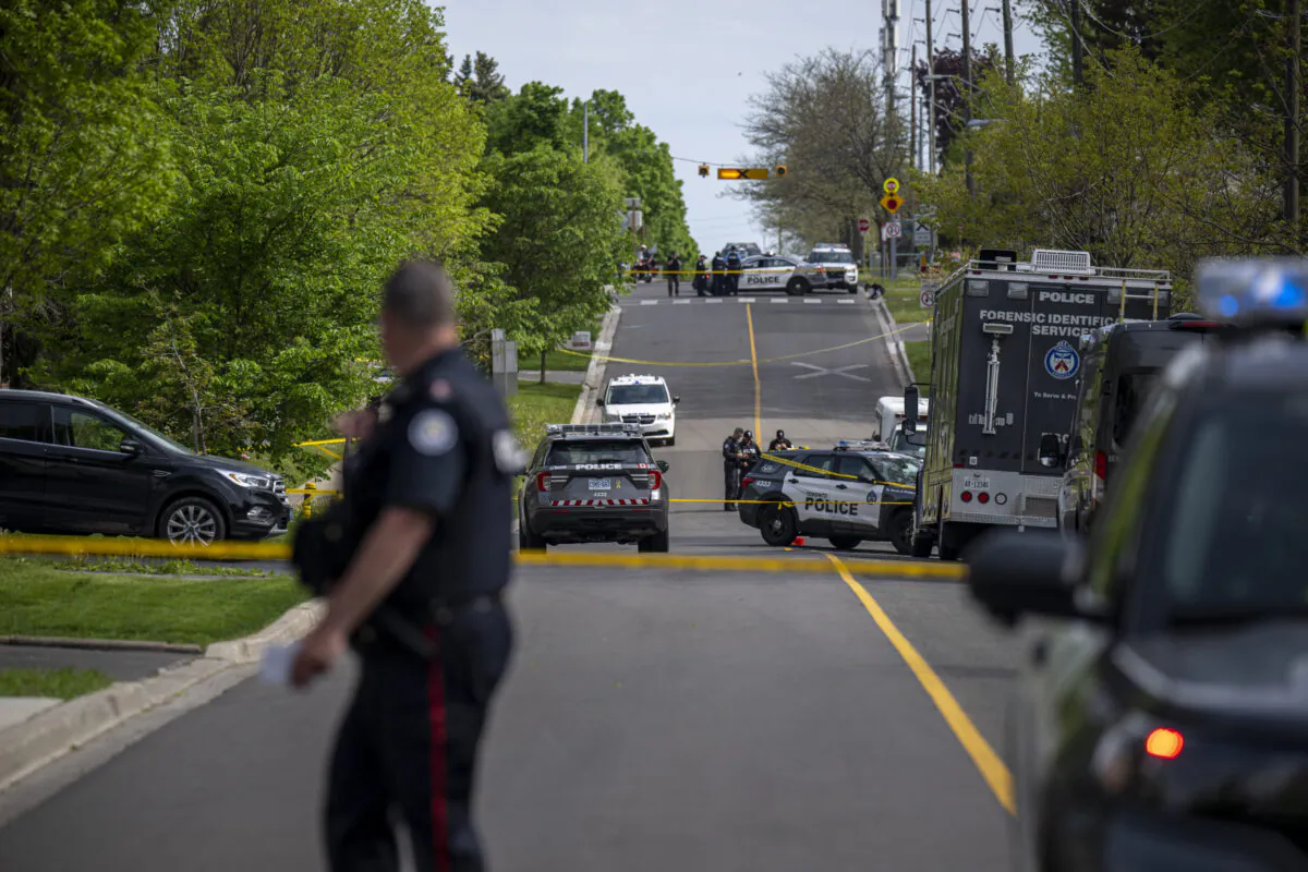 Police and investigators are seen at the scene of a shooting in Toronto, on May 26, 2022. Toronto police say a man has died after an interaction with officers during which a police gun was fired. (The Canadian Press/Aaron Vincent Elkaim)