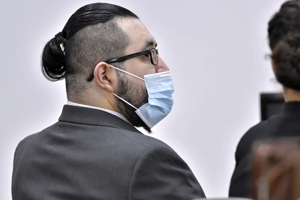 Armando Barron speaks with a member of his defense team during the first day of his trial at Cheshire County Superior Court in Keene, N.H., on May 17, 2022. (Josh Reynolds/AP Photo)