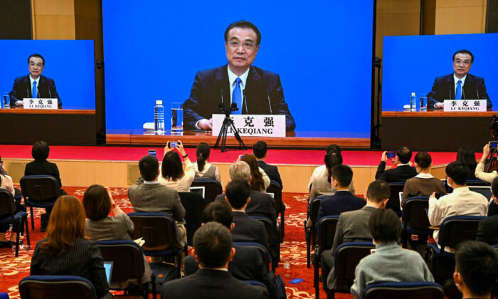 Chinas Premier Li Keqiang speaks via live video transmission during a press conference after the closing session of the National People's Congress at the Great Hall of the People in Beijing on March 11, 2021. (Noel Celis/AFP via Getty Images)
