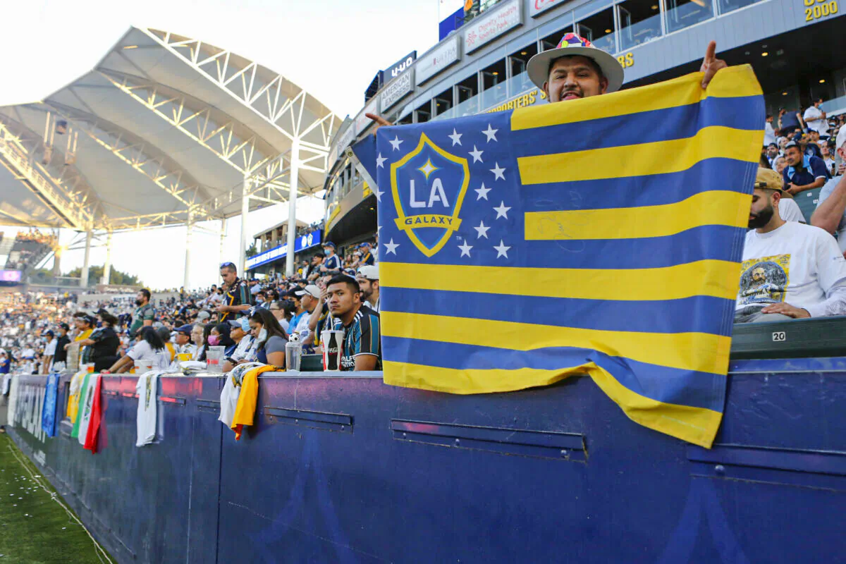 A Los Angeles Galaxy fan holds up a flag during a game against Los Angeles FC at Dignity Health Sports Park, in Carson, Calif., on October 3, 2021. (Katharine Lotze/Getty Images)