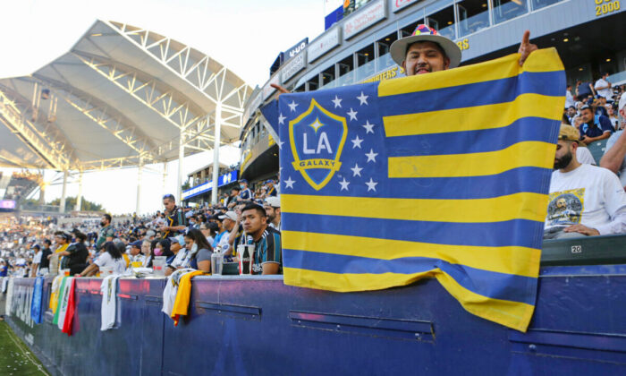 A Los Angeles Galaxy fan holds up a flag during a game against Los Angeles FC at Dignity Health Sports Park, in Carson, Calif., on October 3, 2021. (Katharine Lotze/Getty Images)
