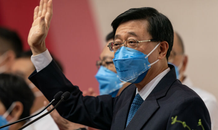 Hong Kong Chief Executive-elect John Lee Ka-chiu waves during a press conference at the Exhibition and Convention Centre in Hong Kong on May 8, 2022. (Anthony Kwan/Getty Images)
