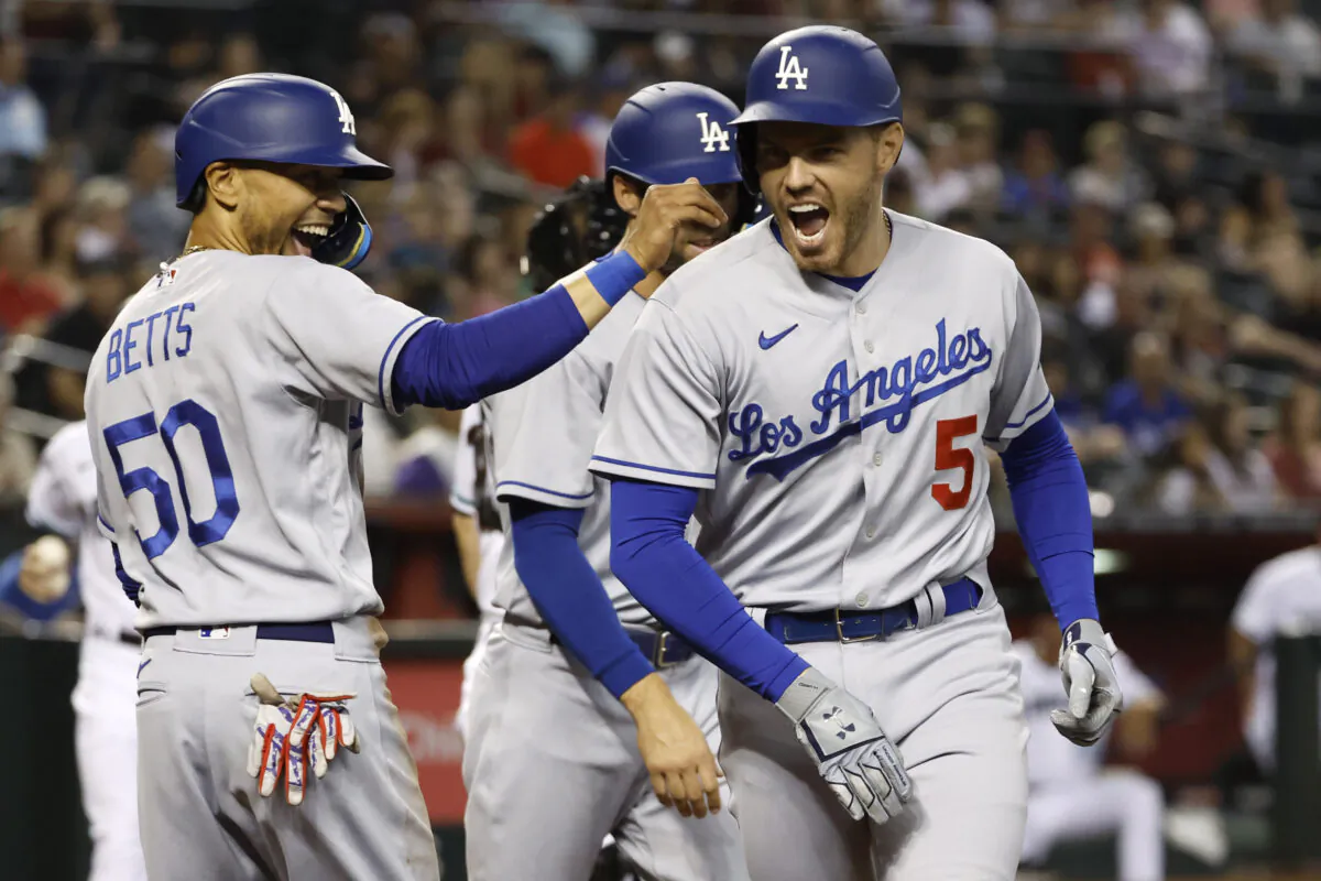 Freddie Freeman #5 of the Los Angeles Dodgers reacts with teammate Mookie Betts #50 after Freeman's three-run home run during the second inning against the Arizona Diamondbacks at Chase Field, in Phoenix, on May 26, 2022. (Chris Coduto/Getty Images)