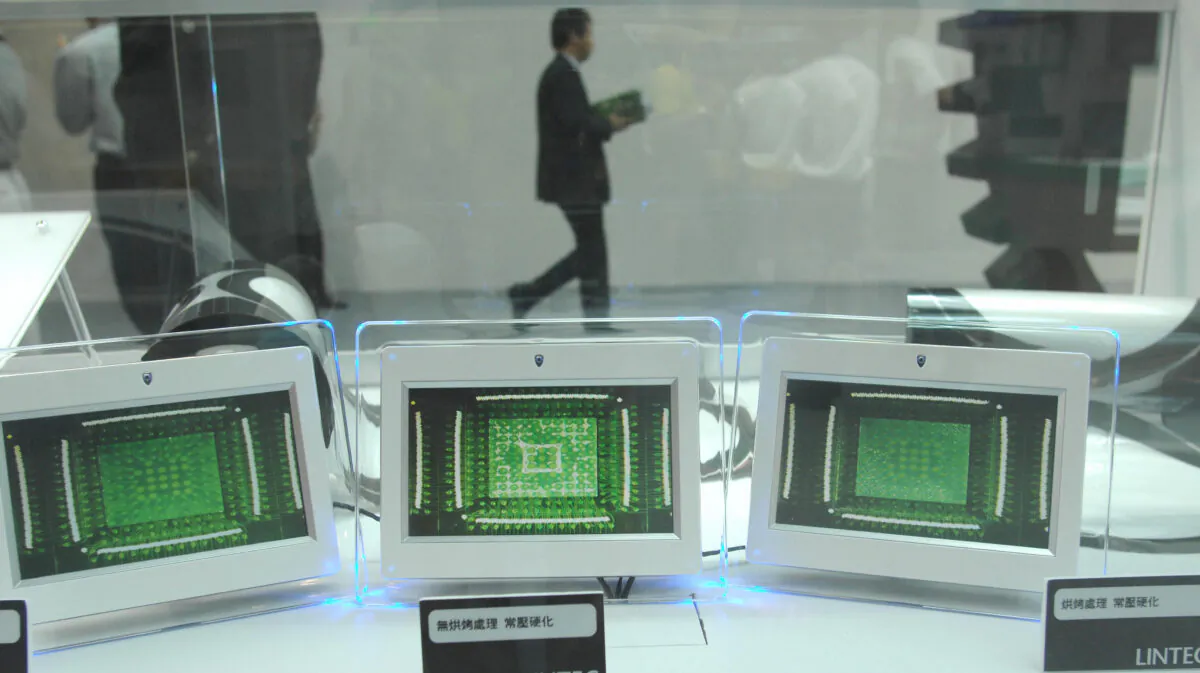 A visitor walks past a booth featuring micropchip testing during the first day of the three-day Semicon semiconductor exhibition at the Taipei World Trade Centre in Taipei, Taiwan, on September 30, 2009. (PATRICK LIN/AFP via Getty Images)