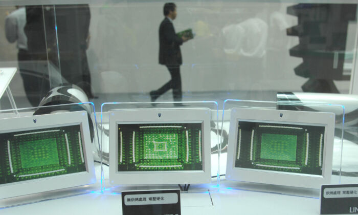 A visitor walks past a booth featuring micropchip testing during the first day of the three-day Semicon semiconductor exhibition at the Taipei World Trade Centre in Taipei, Taiwan, on September 30, 2009. (PATRICK LIN/AFP via Getty Images)