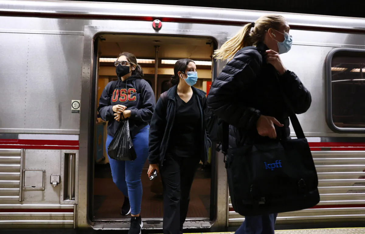 People depart a Los Angeles Metro Rail train in Los Angeles on Dec. 15, 2021. (Mario Tama/Getty Images)