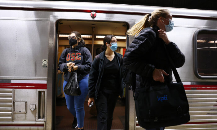People depart a Los Angeles Metro Rail train in Los Angeles on Dec. 15, 2021. (Mario Tama/Getty Images)