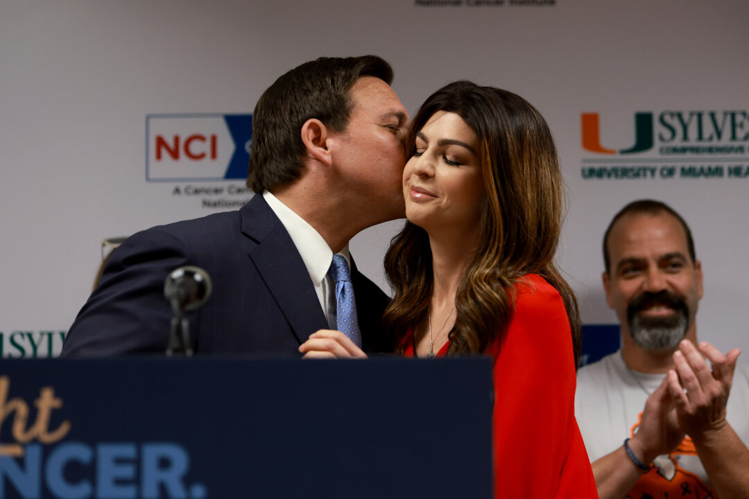 Florida Gov. Ron DeSantis kisses his wife, first lady Casey DeSantis, who recently survived breast cancer, as he introduces her to speak at a press conference at the University of Miami Health System Don Soffer Clinical Research Center on May 17, 2022 in Miami. (Photo by Joe Raedle/Getty Images)
