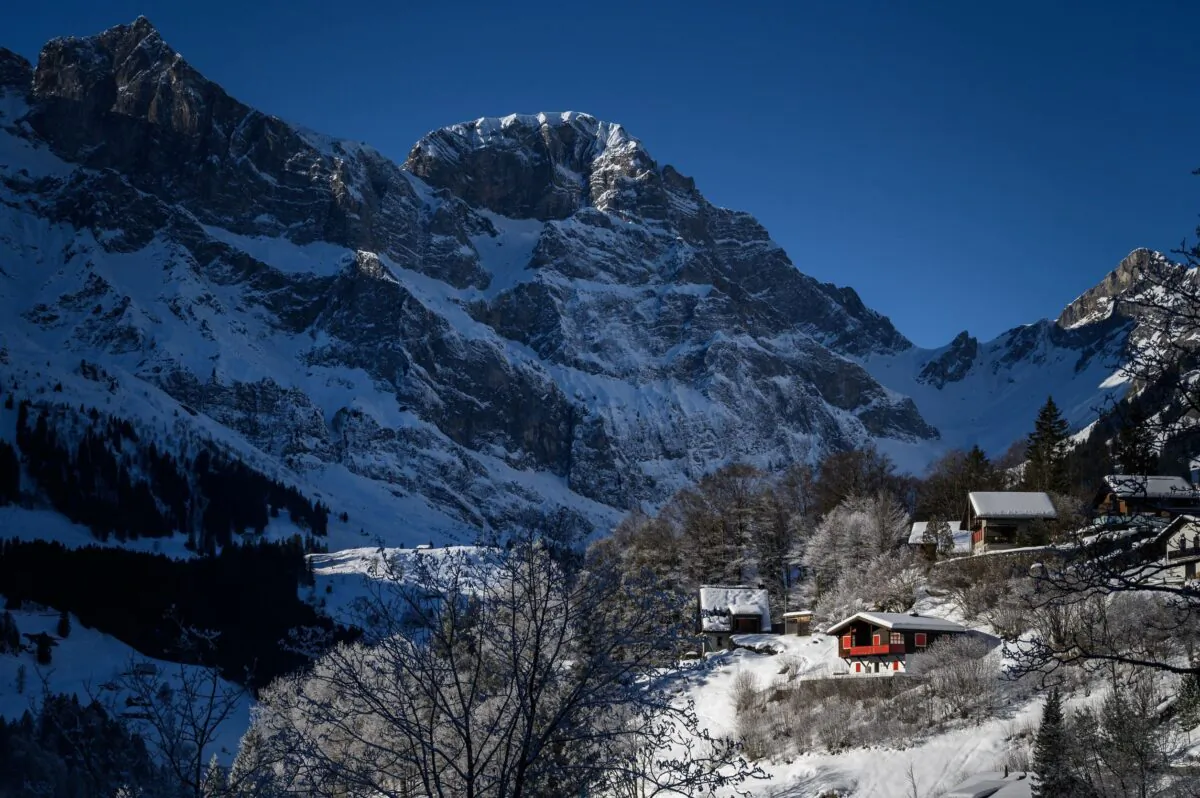Snow-covered chalets at the bottoms of a mountain in the Swiss Alps in Engelberg, on Dec. 18, 2021. (Fabrice Coffrini/AFP via Getty Images)