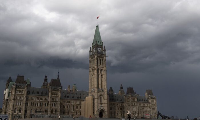 Storm clouds pass by the Peace tower and Parliament hill, in Ottawa, Aug. 18, 2020. (The Canadian Press/Adrian Wyld)