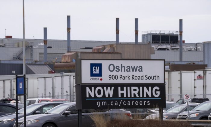 A sign announcing hiring sits at the General Motors facility in Oshawa, Ontario on April 4, 2022. (The Canadian Press/Frank Gunn)