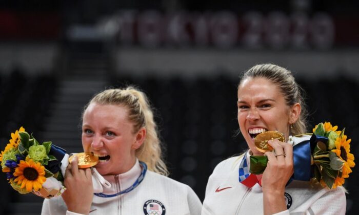 USA's Jordyn Poulter (L) and Andrea Drews pose with their gold medals during the women's volleyball victory ceremony during the Tokyo 2020 Olympic Games at Ariake Arena in Tokyo on August 8, 2021. (Yuri Cortez/AFP via Getty Images)