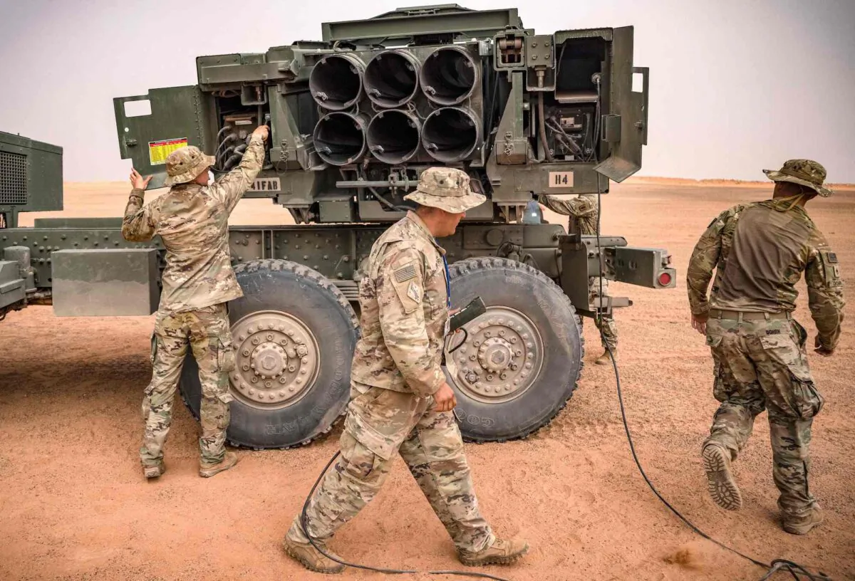 U.S. soldiers are seen attending to an M142 high mobility artillery rocket system (HIMARS) launcher vehicle during a military exercise in the Grier Labouihi region, in Morocco, on June 9, 2021. (Fadel Senna/AFP/Getty Images)