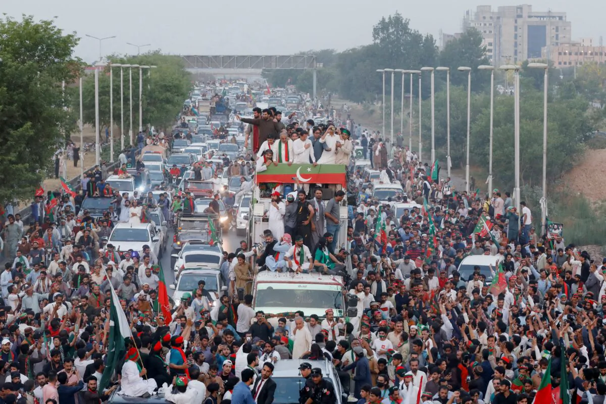 Ousted Pakistani Prime Minister Imran Khan gestures as he travels on a vehicle to lead a protest march in Islamabad, Pakistan, on May 26, 2022. (Akhtar Soomro/Reuters)