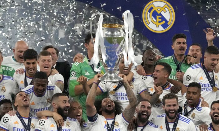 Real Madrid's Marcelo lifts the trophy as players celebrate winning the Champions League final soccer match between Liverpool and Real Madrid at the Stade de France in Saint Denis near Paris, on May 28, 2022. (Frank Augstein/AP Photo)