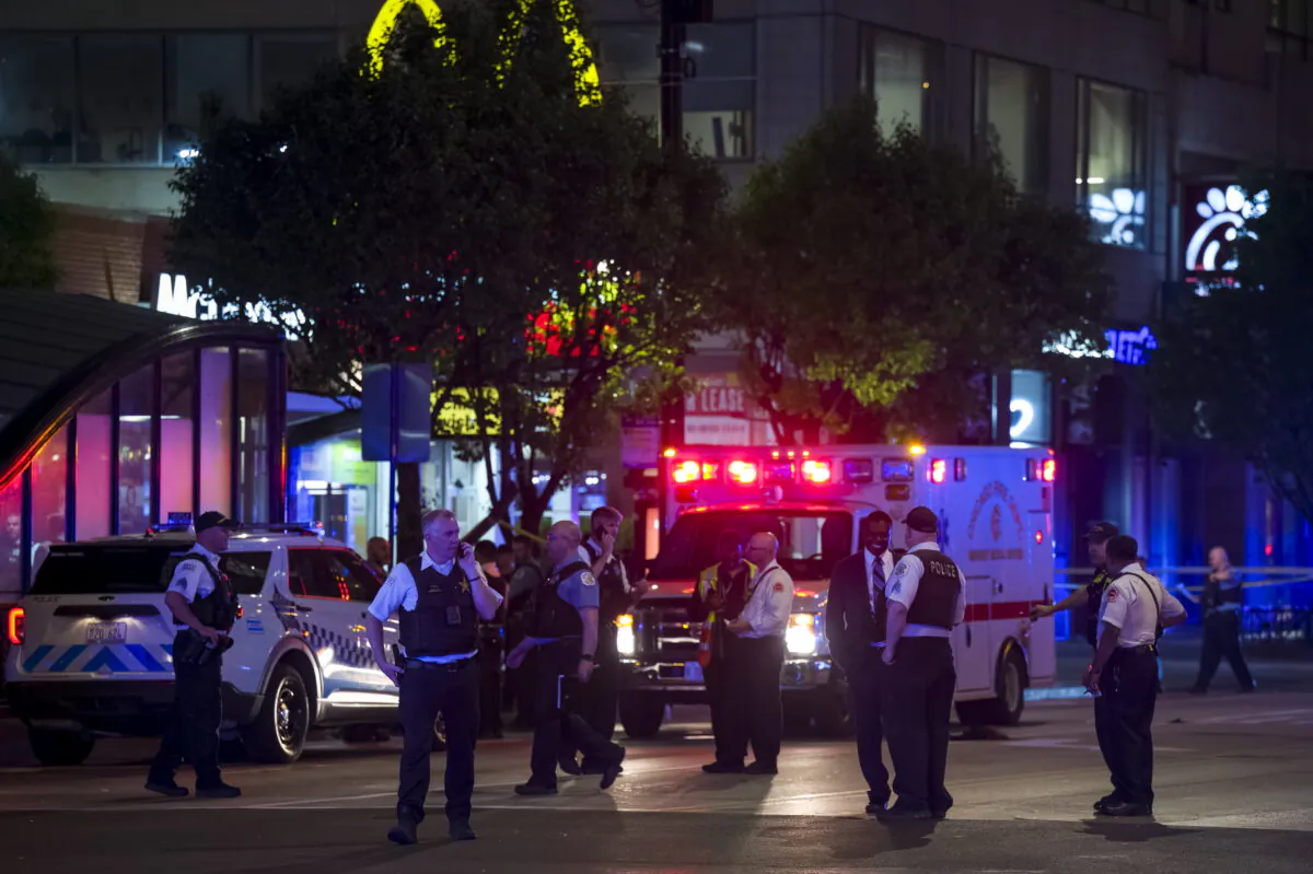 Chicago police work at the scene of a shooting near East Chicago Avenue and North State Street in the Near North Side neighborhood in Chicago on May 19, 2022. (Tyler Pasciak LaRiviere/Chicago Sun-Times via AP)