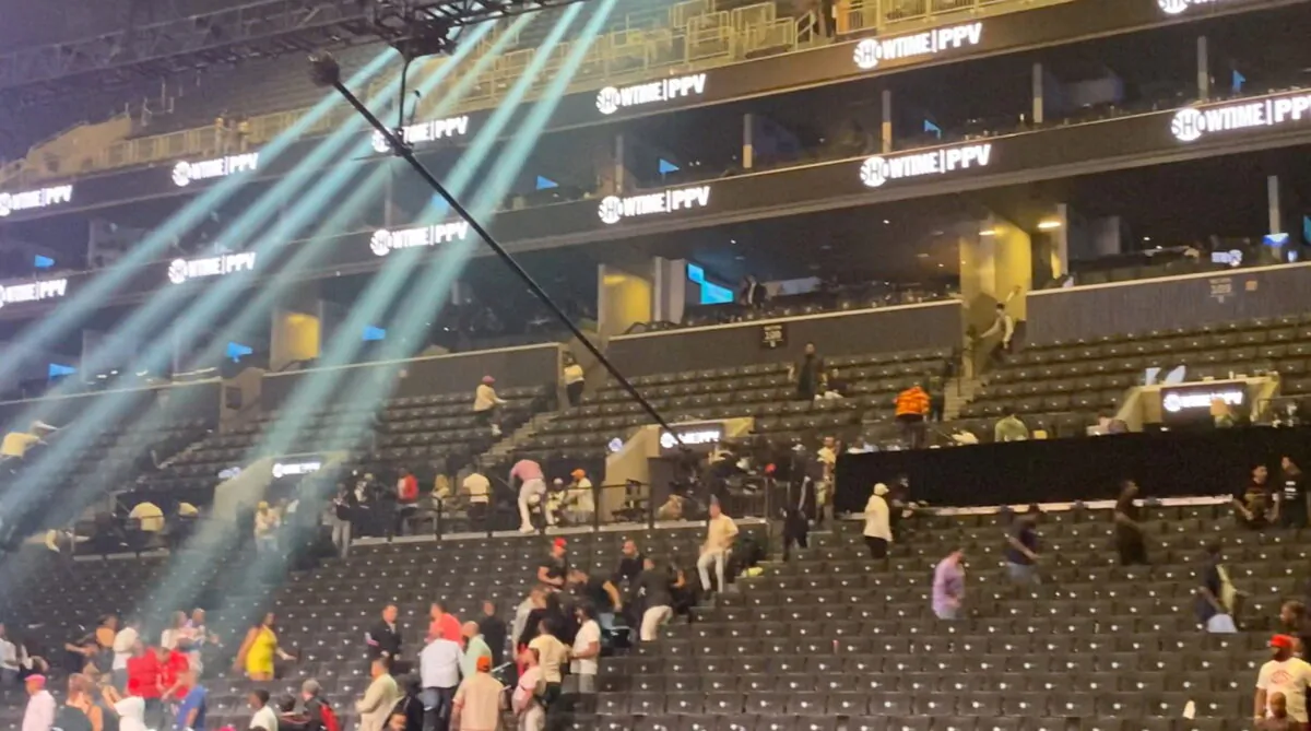 People escape from the tribunes after a false shooting alert inside Barclays Center in New York on May 28, 2022. (Ryan Songalia via Reuters)