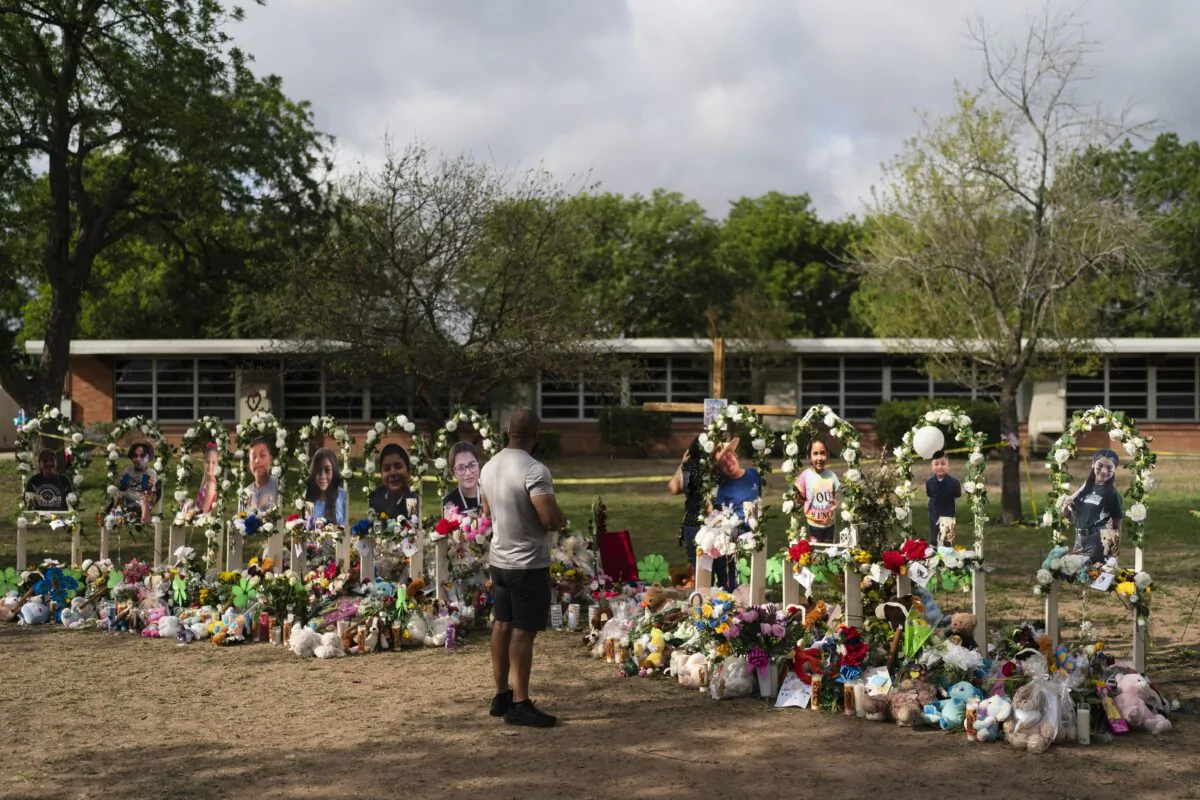 A man pays his respects on May 30, 2022, at a memorial honouring the victims killed in a shooting at Robb Elementary School in Uvalde, Texas, the previous week. (AP Photo/Jae C. Hong)