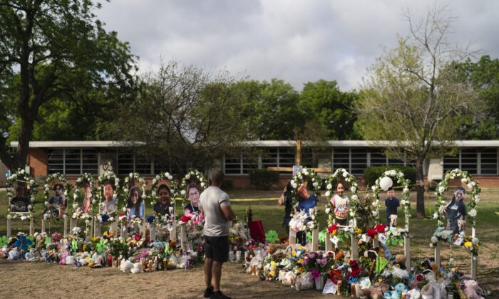 A man pays his respects on May 30, 2022, at a memorial honouring the victims killed in a shooting at Robb Elementary School in Uvalde, Texas, the previous week. (AP Photo/Jae C. Hong)