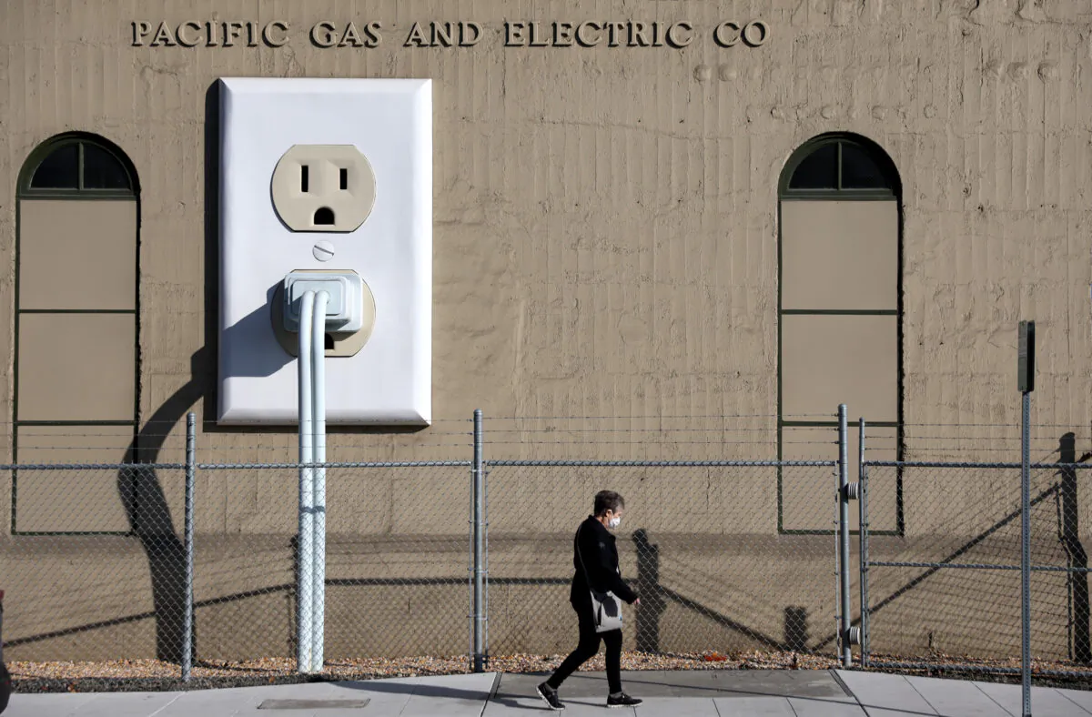 A pedestrian walks by a Pacific Gas & Electric (PG&E) electrical substation in Petaluma, Calif., on Jan. 26, 2022. (Justin Sullivan/Getty Images)