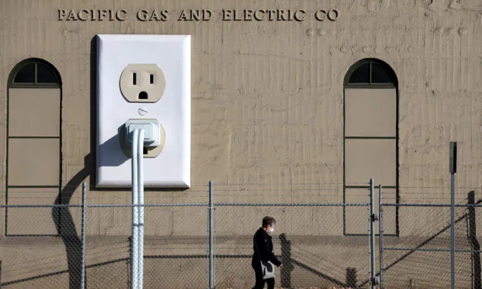 A pedestrian walks by a Pacific Gas & Electric (PG&E) electrical substation in Petaluma, Calif., on Jan. 26, 2022. (Justin Sullivan/Getty Images)