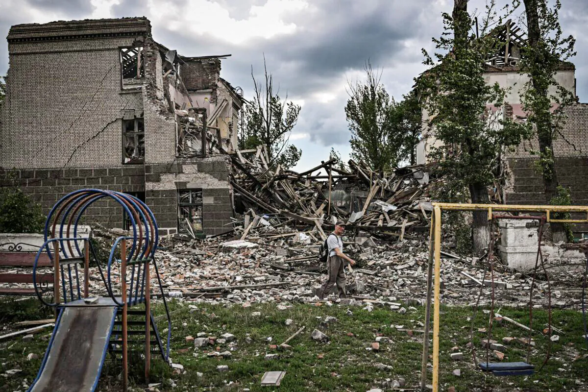 A man walks in front of a destroyed school in the city of Bakhmut, in the eastern Ukranian region of Donbas, on May 28, 2022, on the 94th day of Russia's invasion of Ukraine. (Aris Messinis/AFP via Getty Images)