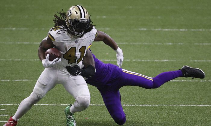 Alvin Kamara #41 of the New Orleans Saints makes a reception past Jeff Gladney #20 of the Minnesota Vikings during the fourth quarter at Mercedes-Benz Superdome in New Orleans, La., on Dec. 25, 2020. (Chris Graythen/Getty Images)