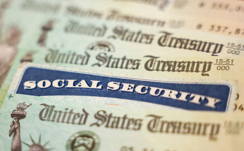 In this photo illustration, a Social Security card sits alongside checks from the U.S. Treasury in Washington, DC on Oct. 14, 2021. (Kevin Dietsch/Getty Images)