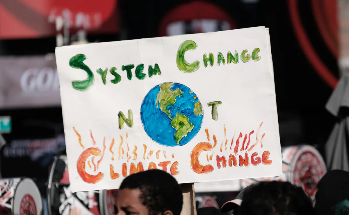 Hundreds of climate protesters walk from Times Square to New York Gov. Kathy Hochul’s office to demand more action against climate change, in New York on Nov. 13, 2021. The protesters, representing a cross section of environmental groups, are demanding that New York State do more to pass legislation that will hold major companies with a history of polluting accountable. (Spencer Platt/Getty Images)