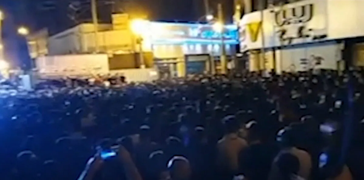 Protesters are angry over a building collapse in southwestern Iran and the crowd confronts officials in Iran on May 29, 2022. (IRIB via AP/Screenshot via The Epoch Times)

