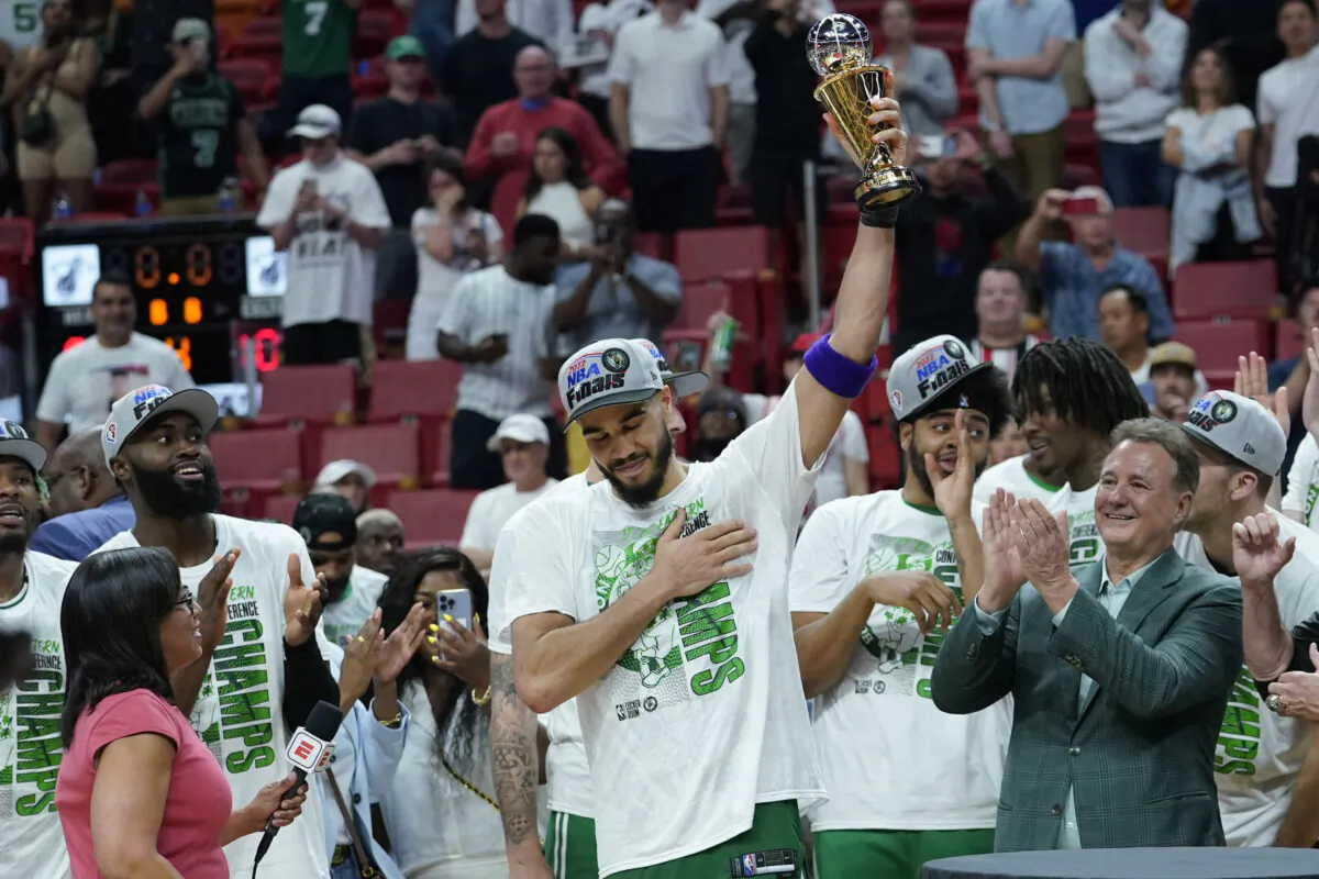 Boston Celtics forward Jayson Tatum raises the NBA Eastern Conference MVP trophy after defeating the Miami Heat in Game 7 of the NBA basketball Eastern Conference finals playoff series in Miami on May 29, 2022. (Lynne Sladky/AP Photo)