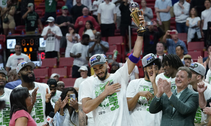 Boston Celtics forward Jayson Tatum raises the NBA Eastern Conference MVP trophy after defeating the Miami Heat in Game 7 of the NBA basketball Eastern Conference finals playoff series in Miami on May 29, 2022. (Lynne Sladky/AP Photo)