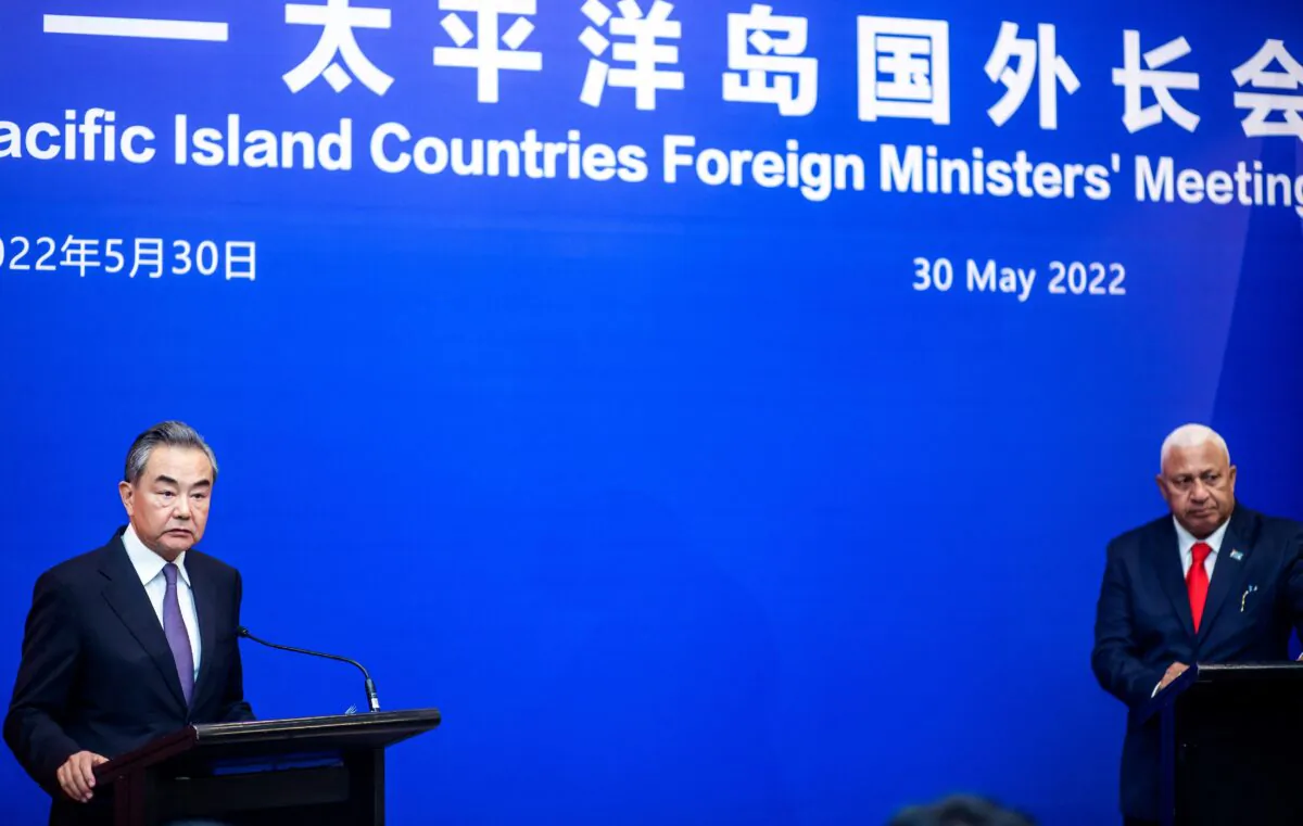 Chinese Foreign Minister Wang Yi (L) speaks during a joint press conference with Fijian Prime Minister Frank Bainimarama in Fiji's capital city Suva on May 30, 2022. (Leon Lord/AFP via Getty Images)